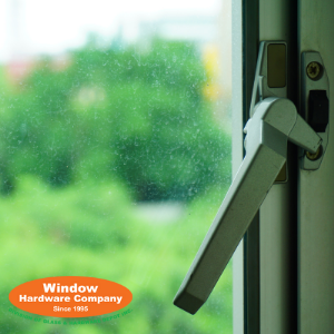casement window lock green trees blurry in distance